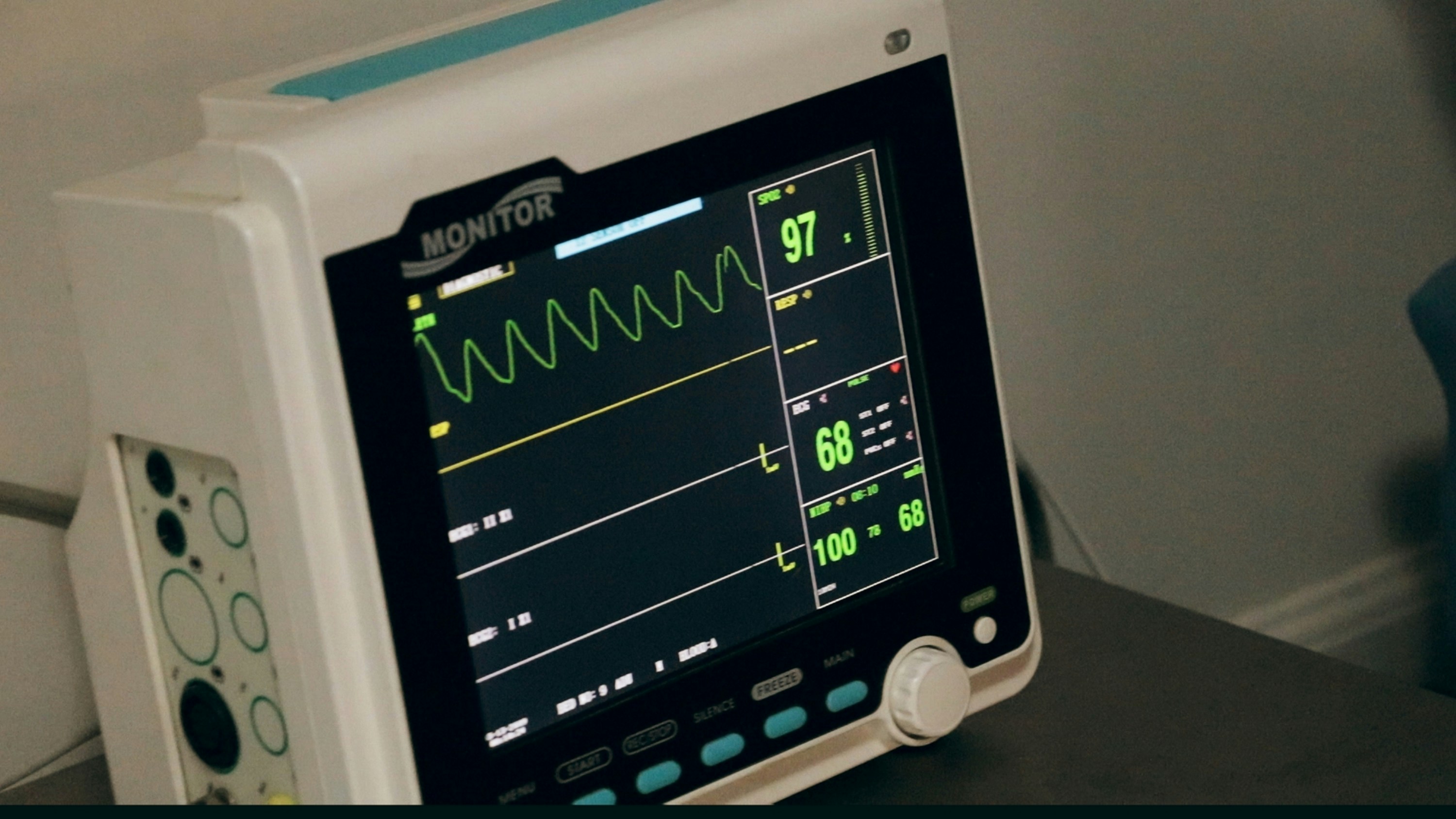 A bedside monitor displaying a patient's vital signs during a training scenario